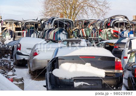 Disassembled cars on a car dump are on sale for spare parts. Disassembled cars on a car dump are on sale for spare parts. 98029997