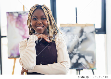 african american woman student in art class inspired and painting african american woman student in art class inspired and painting 98030716