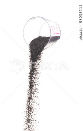 Black Sesame pouring down from measure cup, black Sesame grain wave floating, fall in air. Basil seed is organic healthy food. White background Isolated high speed shutter, freeze stop motion Black Sesame pouring down from measure cup, black Sesame grain wave floating, fall in air. Basil seed is organic healthy food. White background Isolated high speed shutter, freeze stop motion 98033515