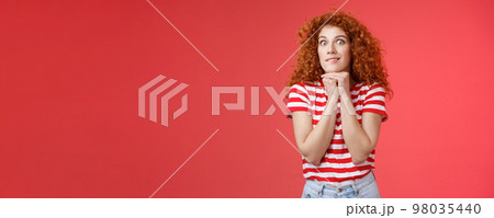 Excited thrilled young impulsive good-looking redhead female stare camera express desire aspiration smiling crazy hold hands chin pressed keep herself together wanna have something eager eat Excited thrilled young impulsive good-looking redhead female stare camera express desire aspiration smiling crazy hold hands chin pressed keep herself together wanna have something eager eat 98035440