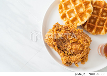 fried chicken waffle with honey or maple syrup 98038059