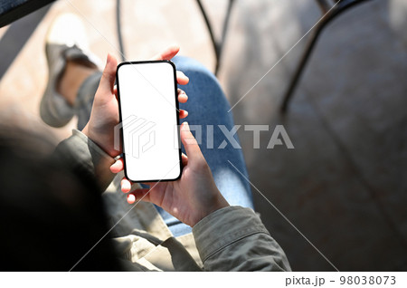 Above view, Asian woman using her mobile phone while relaxing in the cafe. 98038073