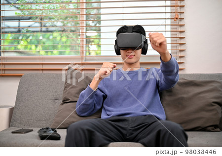 Excited and joyful young Asian man wearing VR...の写真素材 [98038446] - PIXTA