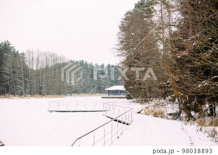 Beautiful winter landscape of a frozen lake and a lot of snow Beautiful winter landscape of a frozen lake and a lot of snow 98038893
