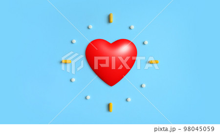 Red heart with pills, medical capsules on blue background Red heart with pills, medical capsules on blue background 98045059