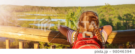 Girl standing on the observation tower on the Viru bog. Girl standing on the observation tower on the Viru bog. 98046394