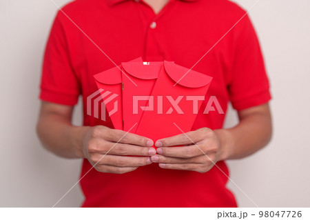 man holding Chinese red envelope, money gift for happy Lunar New Year holiday 98047726