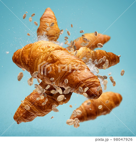 Freshly baked croissant flying in air 98047926
