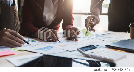 Asian business adviser meeting to analyze and discuss the situation on the financial report in the meeting room.Investment Consultant, Financial advisor and accounting concept 98048977