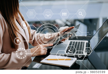 Copyright or patent concept, Person hand using laptop computer, tablet and smartphone with virtual screen copyright icon trademark, Creation ownership against piracy. 98050599