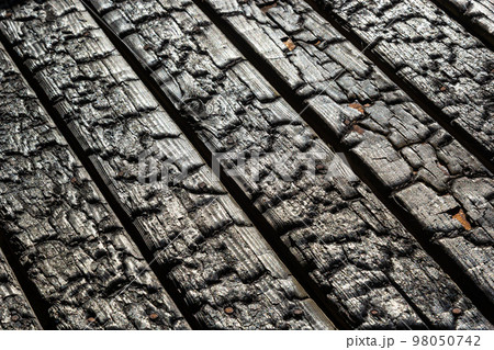BBQ background. Burnt wooden Board texture. Burned scratched hardwood surface. Smoking wood plank background. Burned wooden grunge texture BBQ background. Burnt wooden Board texture. Burned scratched hardwood surface. Smoking wood plank background. Burned wooden grunge texture 98050742