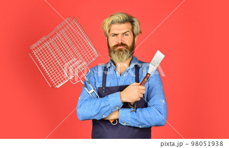 Bbq american tradition. Hipster dyed beard promoting bbq equipment. Cooking healthy. Bbq food. Culinary concept. Tools roasting meat. Man in apron hold barbecue grill. Cooking utensils. Summer picnic 98051938