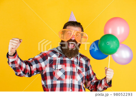full of happiness. stylish male having fun on birthday. bearded man celebrate holiday. anniversary. surprise for him. event manager with gift. mature guy in checkered shirt with party balloons 98052293