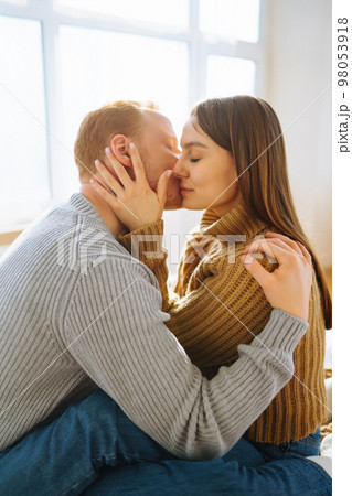 Couple in love relaxing at home on bed while they hug each other. Valentine's Day, holiday concept. 98053918