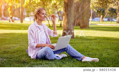 Businesswoman sitting grass Businesswoman sitting grass 98055436