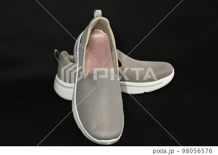 Women's shoes, slipons, on a dark background, top view. 98056576
