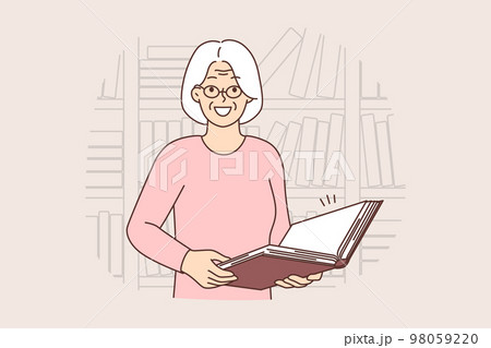 Smiling old woman with book in library Smiling old woman with book in library 98059220
