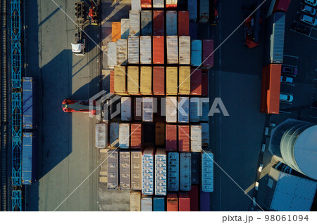 Shipping containers in terminal, Unloading containers in warehouse on railroad platform with cranes and forklifts, aerial view 98061094
