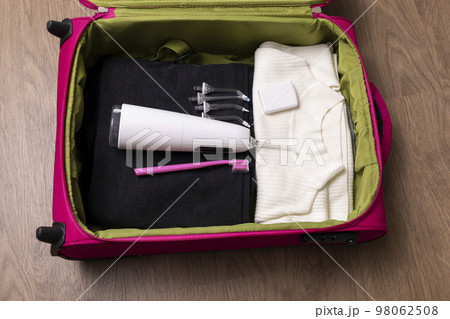 Dental teeth care set in suitcase, travel concept. Water teeth irrigator with nozzle pack, toothbrush, floss in luggage on wooden floor. Home dental care device. Horizontal plane Dental teeth care set in suitcase, travel concept. Water teeth irrigator with nozzle pack, toothbrush, floss in luggage on wooden floor. Home dental care device. Horizontal plane 98062508