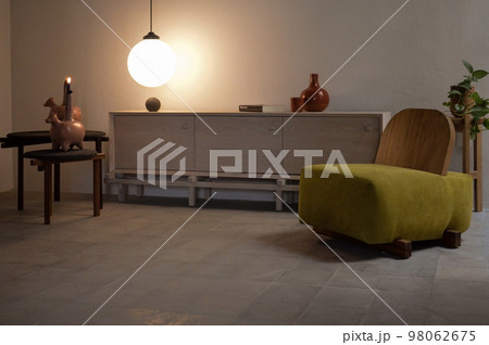 Interior design of cozy living room with stylish sofa, coffee table, dired flowers in vase 98062675