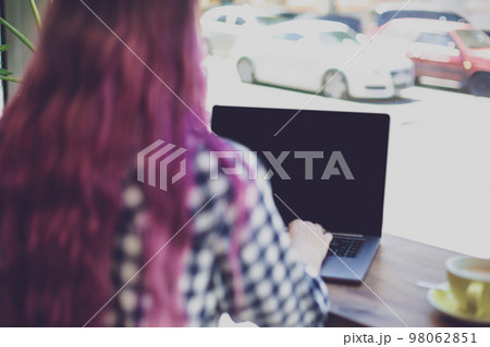 Woman typing on notebook with blank screen with copy space for y Woman typing on notebook with blank screen with copy space for y 98062851