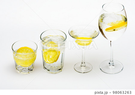 Detox after party. Health care concept. What to drink on party. Cocktail glasses with water slice of lemon isolated on white. Alcohol harmful influence. Detox drink to feel better. Hangover and detox Detox after party. Health care concept. What to drink on party. Cocktail glasses with water slice of lemon isolated on white. Alcohol harmful influence. Detox drink to feel better. Hangover and detox 98063263