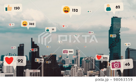 Social media icons fly over city downtown showing people reciprocity connection Social media icons fly over city downtown showing people reciprocity connection 98063559