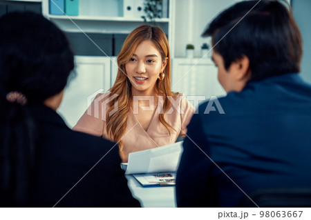 Young female asian candidate tries to impress interviewer by being competent. 98063667