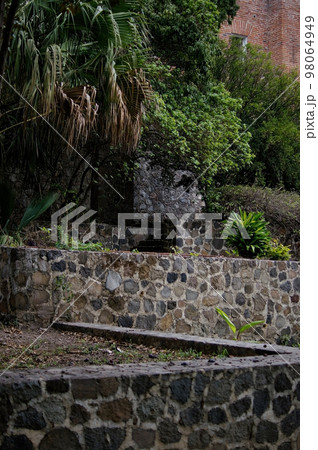 stone bases, masonry. Platforms with vegetation, plants and trees, stairs, red brick 98064949