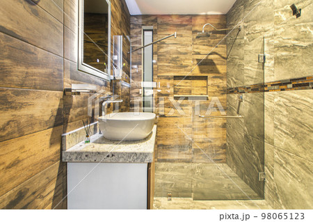 bathroom with luxury finishes, main mirror with led light from behind, white ceramic washbasin bathroom with luxury finishes, main mirror with led light from behind, white ceramic washbasin 98065123