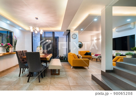 contemporary living and dining room, modern architecture interior, orange armchairs, solid wood table contemporary living and dining room, modern architecture interior, orange armchairs, solid wood table 98065208
