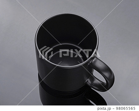Black mug on black background, top view Black mug on black background, top view 98065565