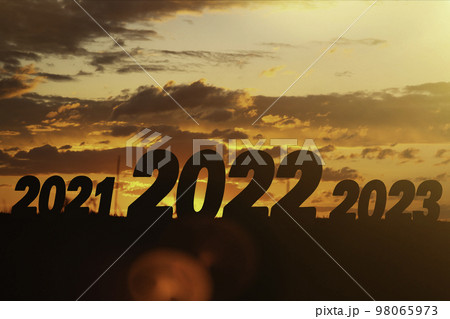 Year change. The beginning of a new year. New year concept. Symbol of start and greetings happy new year 2022. People enter 2022. 98065973
