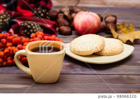 Autumn still life - coffee, cookies, a plaid, a notebook and a pencil on a wooden background Autumn still life - coffee, cookies, a plaid, a notebook and a pencil on a wooden background 98066320