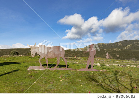 Mountains. Green mountains in the municipality of El Atazar, north of the Community of Madrid. Sunny day with air and clouds decorating the sky. Iron decoration on the green grass. Farmer. Donkey. Mountains. Green mountains in the municipality of El Atazar, north of the Community of Madrid. Sunny day with air and clouds decorating the sky. Iron decoration on the green grass. Farmer. Donkey. 98066682
