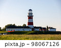 Lighthouse in red and white colors on the seashore, river bank or lake shore. Lighthouse hotel in a fishing village. Travel and tourism concept. Russia, Ryazan region, near the village Shumash. 98067126