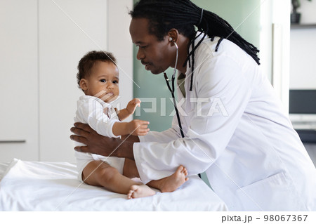 Baby Check Up. Black Pediatrician Doctor Examining Little Infant Boy In Clinic 98067367