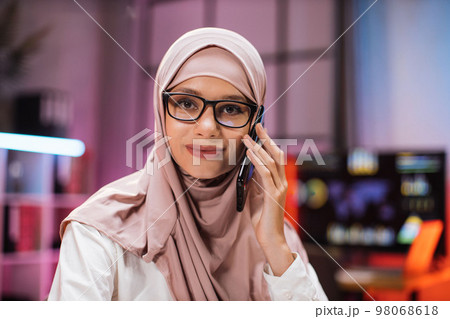 Close up portrait of attractive concentrated hardworking muslim businesswoman 98068618