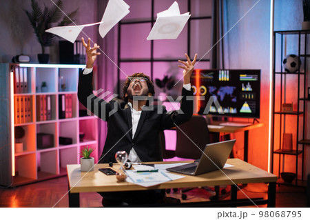 Overjoyed young bearded businessman in suit getting good news, making good deal, throwing papers 98068795