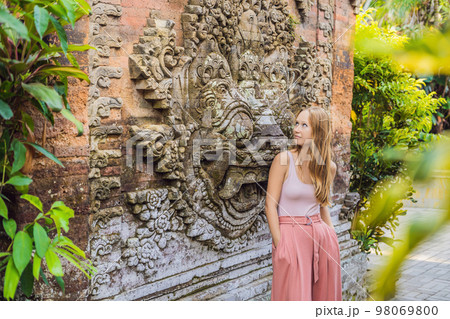 Young woman traveler in Ubud palace, Bali - Inside the Ubud palace, Bali, Indonesia 98069800
