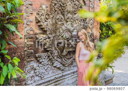 Young woman traveler in Ubud palace, Bali - Inside the Ubud palace, Bali, Indonesia 98069807