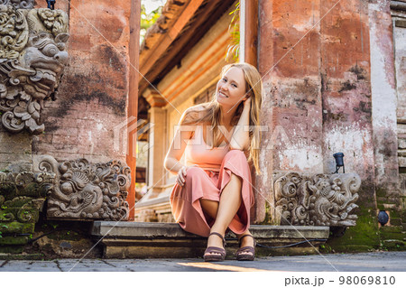 Young woman traveler in Ubud palace, Bali - Inside the Ubud palace, Bali, Indonesia Young woman traveler in Ubud palace, Bali - Inside the Ubud palace, Bali, Indonesia 98069810