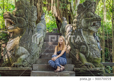Young woman tourist explores the Monkey Forest in Ubud, Bali, Indonesia 98070059
