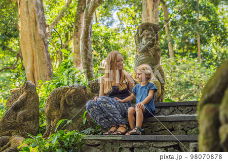 Mom and son travelers discovering Ubud forest in Monkey forest, Bali Indonesia. Traveling with children concept Mom and son travelers discovering Ubud forest in Monkey forest, Bali Indonesia. Traveling with children concept 98070878