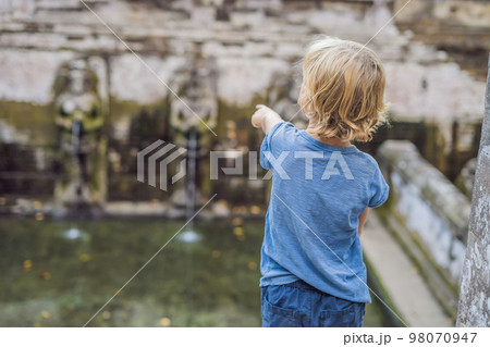Boy tourist in Old Hindu temple of Goa Gajah near Ubud on the island of Bali, Indonesia. Travel in Bali with children concept 98070947