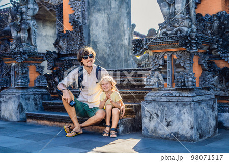 Father and son tourists on the background of Tanah Lot - Temple in the Ocean. Bali, Indonesia. Traveling with children concept 98071517