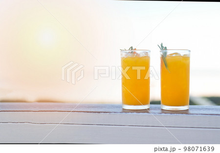 glass of orange juice on wooden table, fresh orange Juice with orange fruit and rosemary in the morning view nature background glass of orange juice on wooden table, fresh orange Juice with orange fruit and rosemary in the morning view nature background 98071639