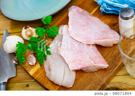 Unprepared chicken fillets on kitchen table 98071804