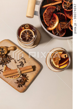 Christmas drink Vin Chaud, French mulled wine ingredients_cinnamon and dried fruits 98074047