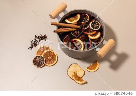 Christmas drink Vin Chaud, French mulled wine ingredients_cinnamon and dried fruits 98074049